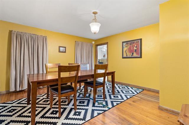 dining space featuring baseboards and light wood-style floors