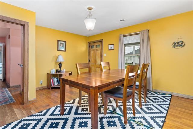 dining space with light wood-style floors and baseboards