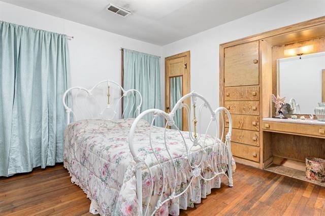 bedroom featuring hardwood / wood-style floors and visible vents