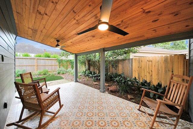 view of patio with a fenced backyard and ceiling fan