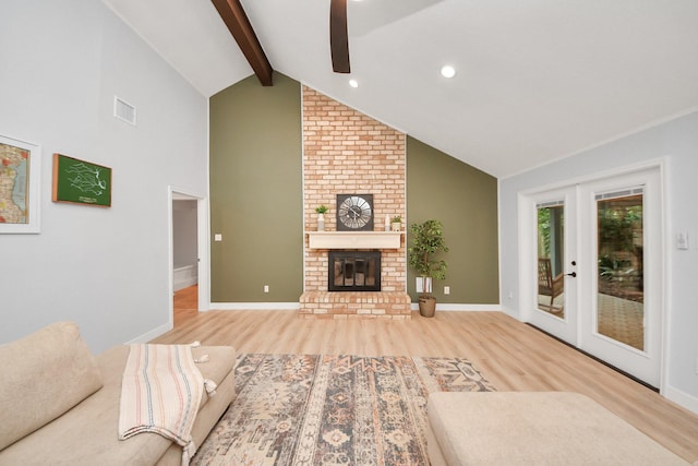 unfurnished living room with a fireplace, a ceiling fan, baseboards, wood finished floors, and beamed ceiling