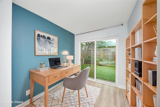 office with baseboards and light wood-style flooring
