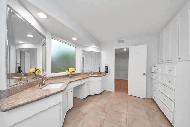 bathroom featuring a sink, recessed lighting, double vanity, and visible vents