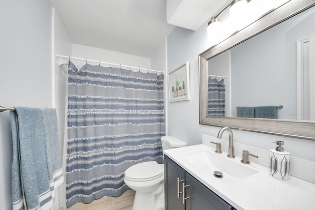 full bath with vanity, curtained shower, toilet, and wood finished floors