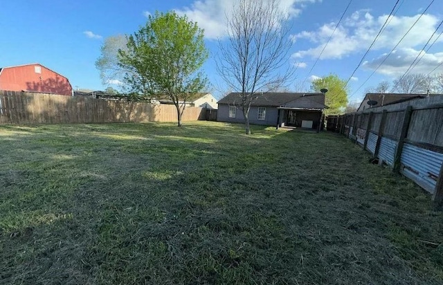 view of yard with a fenced backyard