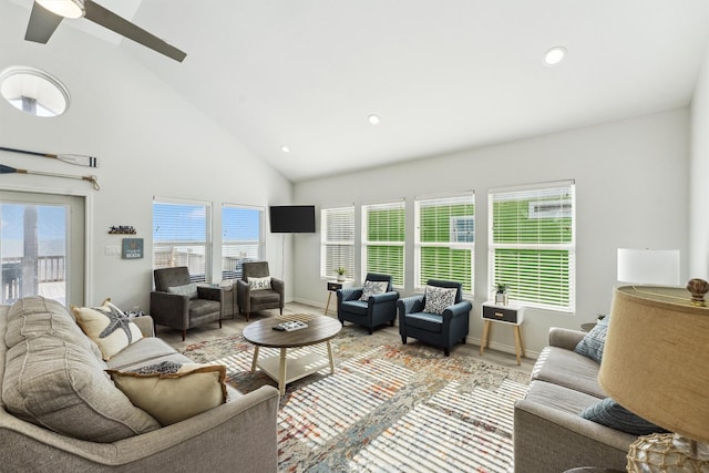 living area with baseboards, recessed lighting, light wood-style floors, ceiling fan, and high vaulted ceiling