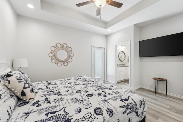 bedroom with recessed lighting, a ceiling fan, connected bathroom, baseboards, and light wood-style flooring
