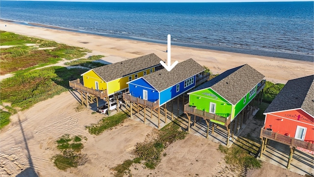 birds eye view of property featuring a beach view and a water view