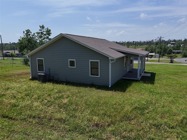 view of property exterior featuring a yard and central air condition unit