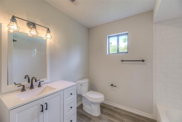 full bathroom featuring wood finished floors, visible vents, toilet, vanity, and baseboards