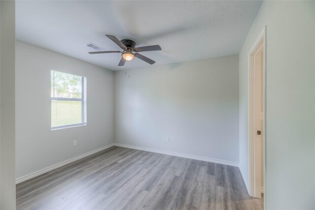646 Yaupon Cove Dr, Onalaska, TX 77360 - spare room featuring baseboards, wood finished floors, visible vents, and a ceiling fan