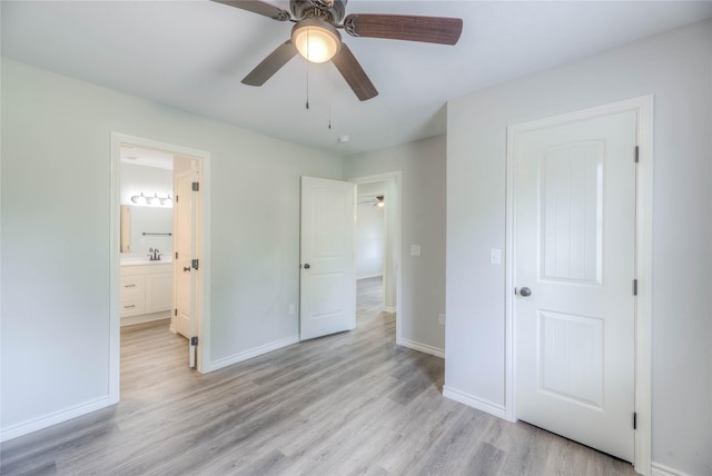 unfurnished bedroom with light wood-style flooring, baseboards, a sink, and ceiling fan