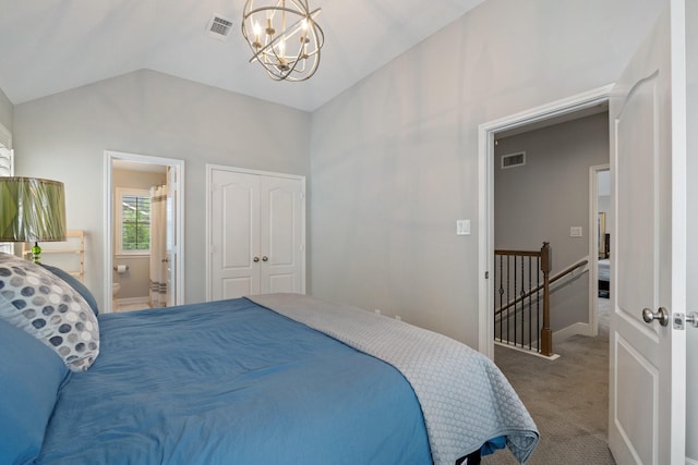 bedroom with visible vents, vaulted ceiling, carpet floors, a notable chandelier, and ensuite bath