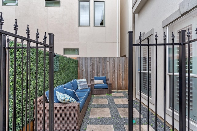 view of patio featuring an outdoor living space and fence