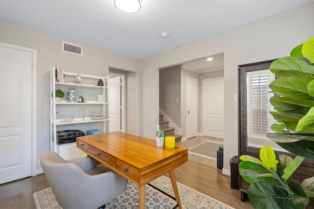 home office featuring baseboards, wood finished floors, and visible vents