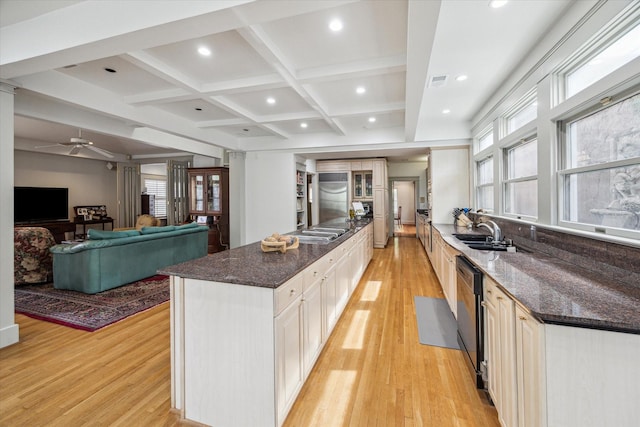 kitchen with light wood finished floors, recessed lighting, and a sink