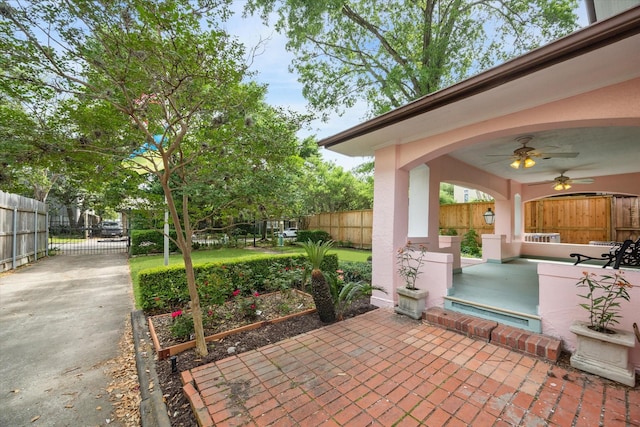 view of patio / terrace with ceiling fan and fence private yard