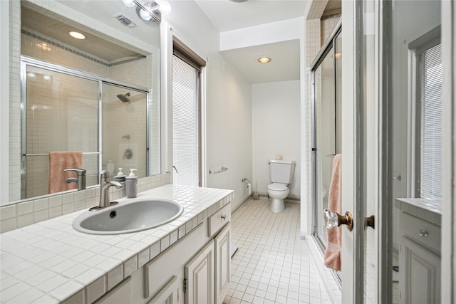 full bathroom featuring visible vents, a stall shower, toilet, tile patterned floors, and vanity