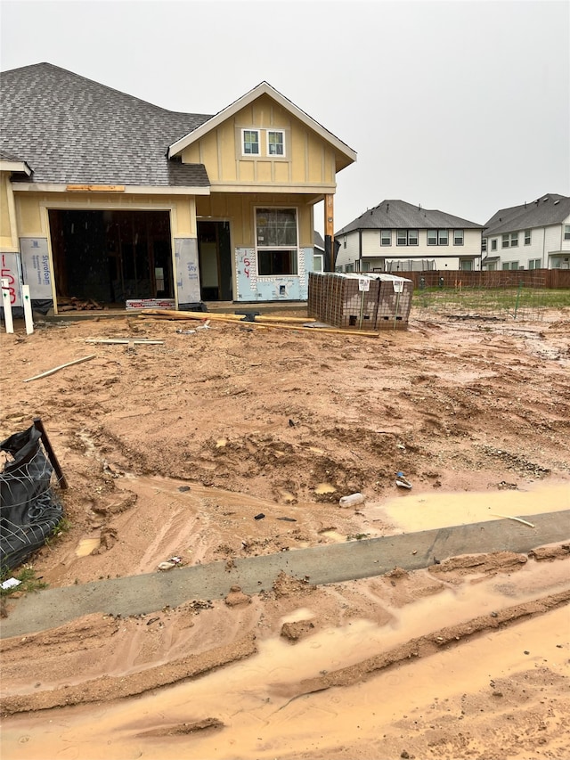 154 W Coralburst Loop, Montgomery, TX 77316 - view of front facade with board and batten siding, fence, a garage, a shingled roof, and a porch