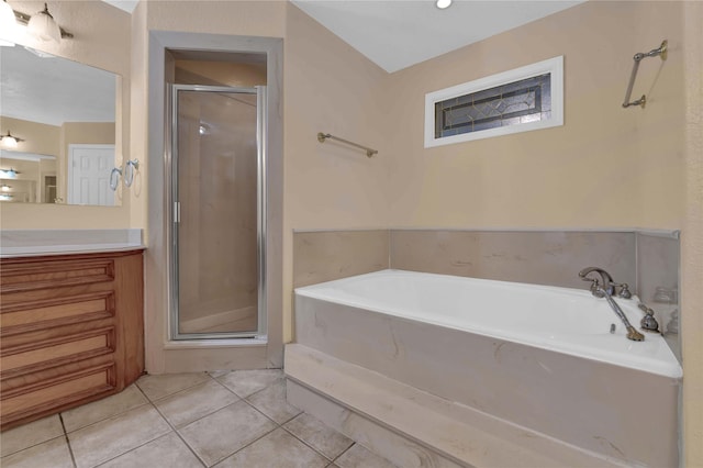 bathroom featuring a garden tub, vanity, tile patterned floors, and a stall shower
