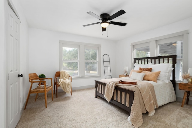 carpeted bedroom featuring a ceiling fan and baseboards