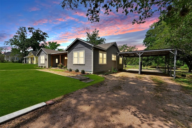 view of front of home with a carport, driveway, and a front lawn