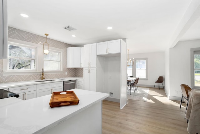 kitchen featuring visible vents, a wealth of natural light, stainless steel dishwasher, and a sink