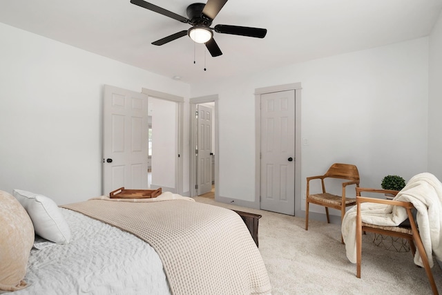 bedroom with a ceiling fan and light colored carpet