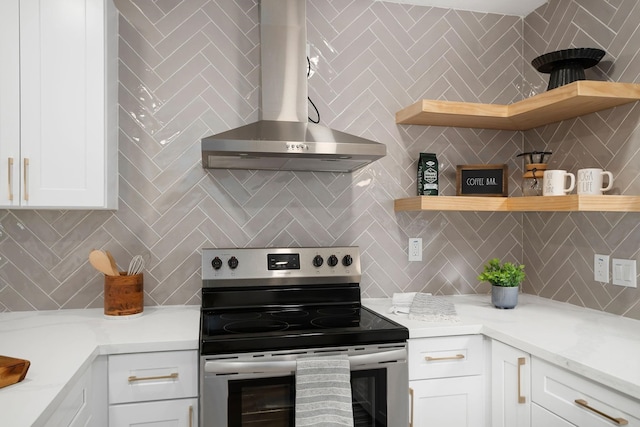 kitchen with wall chimney exhaust hood, open shelves, tasteful backsplash, and electric range