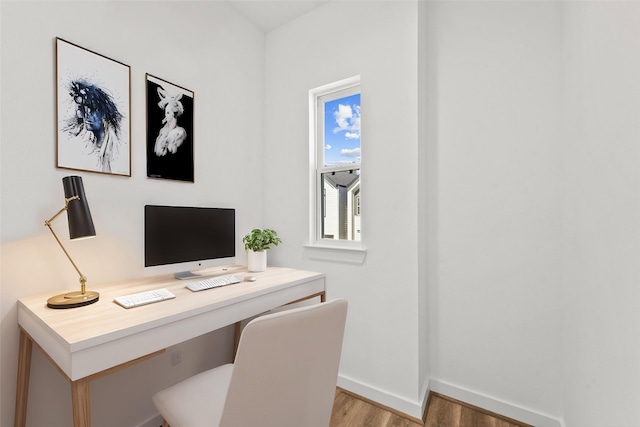 office area with baseboards and light wood-style floors