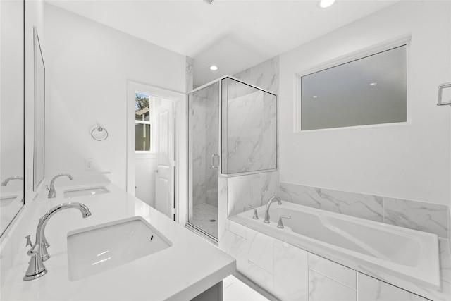 bathroom featuring a marble finish shower, a sink, and recessed lighting