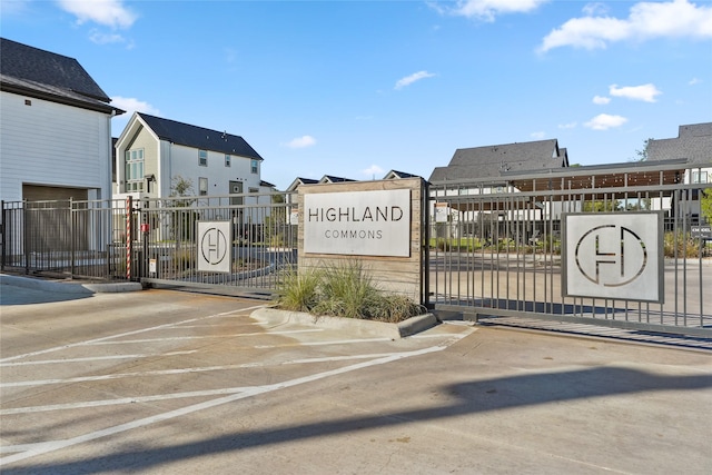 view of gate with fence and a residential view