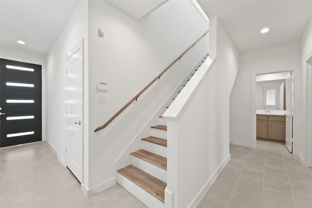 entrance foyer featuring baseboards, recessed lighting, stairs, and light tile patterned flooring