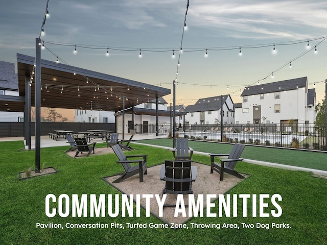 view of home's community featuring a lawn and fence