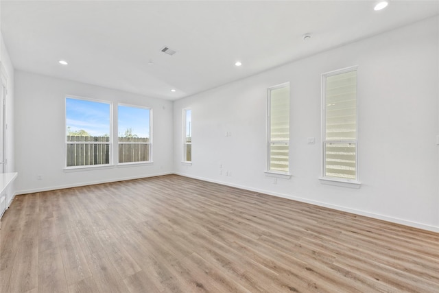 unfurnished living room featuring recessed lighting, light wood-style floors, visible vents, and baseboards