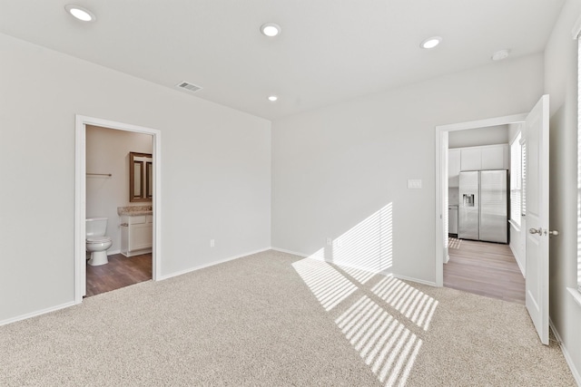 2116 Cedar Bend Dr, Conroe, TX 77306 - unfurnished bedroom with recessed lighting, carpet, visible vents, baseboards, and stainless steel refrigerator with ice dispenser