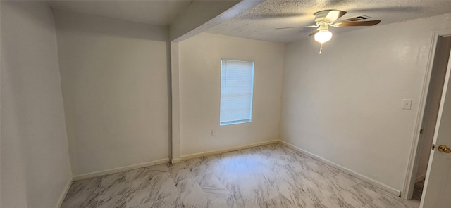 unfurnished room featuring a textured ceiling, a ceiling fan, baseboards, and visible vents
