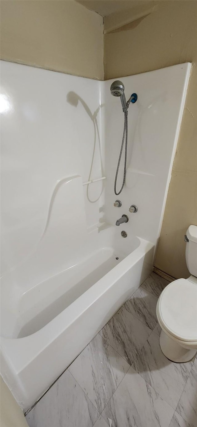 full bathroom featuring marble finish floor and toilet