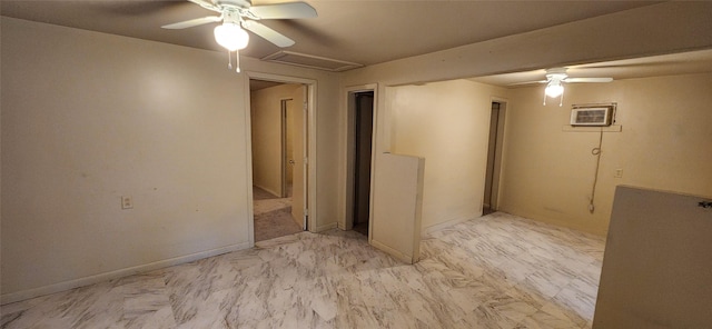 unfurnished room with attic access, a wall mounted air conditioner, and a ceiling fan
