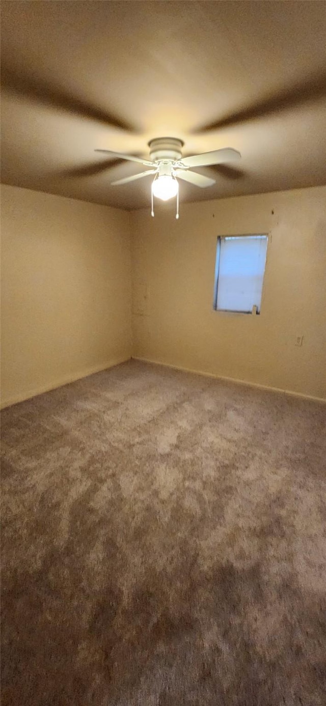 empty room with carpet floors and ceiling fan