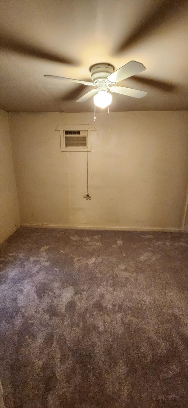 carpeted spare room featuring a ceiling fan and a wall mounted AC