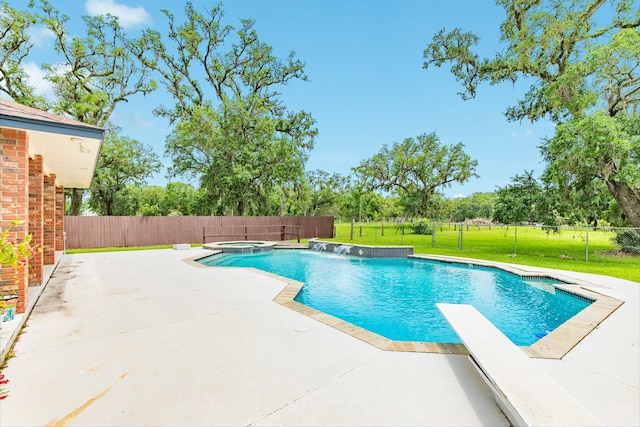 view of swimming pool with a yard, a patio, a fenced backyard, and a diving board