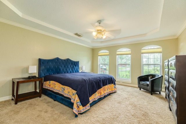 carpeted bedroom with a raised ceiling, visible vents, crown molding, and a ceiling fan
