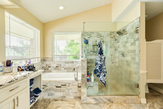 bathroom featuring vaulted ceiling, a stall shower, a bath, vanity, and recessed lighting