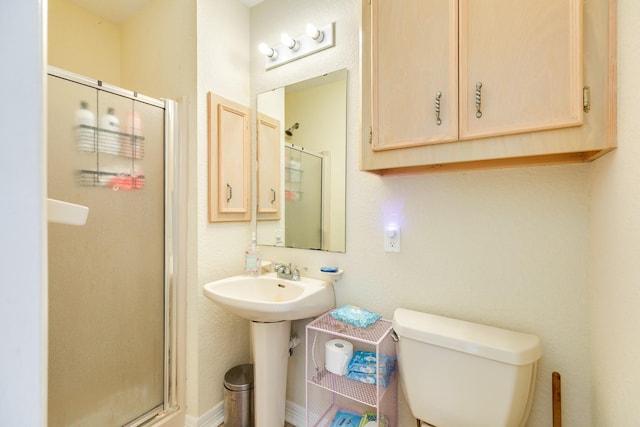 bathroom with toilet and a stall shower