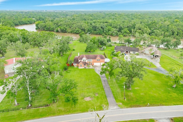 drone / aerial view with a water view and a wooded view
