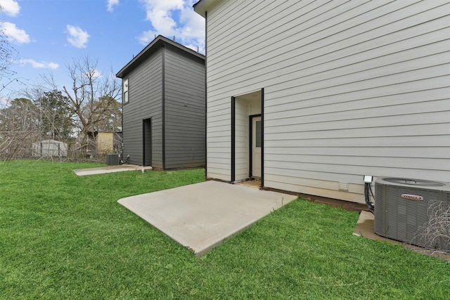 8685 Sassafras St, Willis, TX 77318 - back of house with a patio area, a lawn, and central AC
