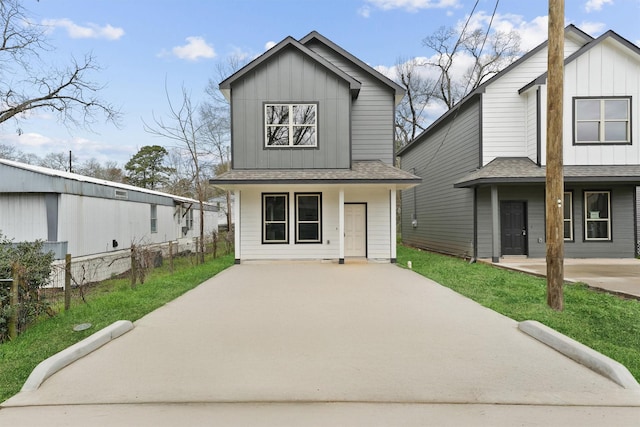 8685 Sassafras St, Willis, TX 77318 - view of front of home with board and batten siding, a shingled roof, driveway, and covered porch