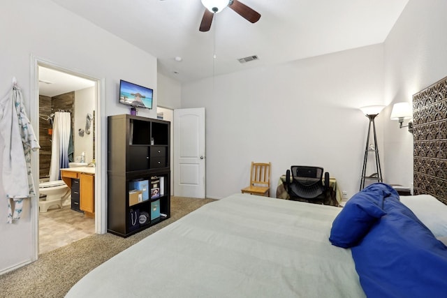 carpeted bedroom featuring visible vents, connected bathroom, and ceiling fan