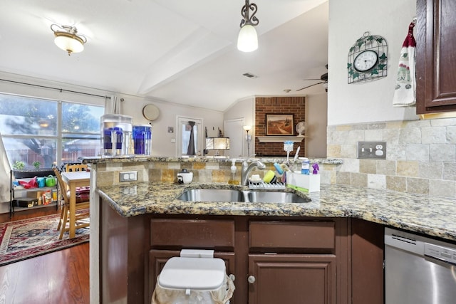 kitchen featuring stainless steel dishwasher, a ceiling fan, a sink, lofted ceiling with beams, and a peninsula